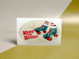 <img src=”Oval-Stickers-and-Oval-Labels.jpg” alt=”Custom Oval Stickers with gray color background and a pair of rollers in center with "Keep on Rollin'" text in center”>